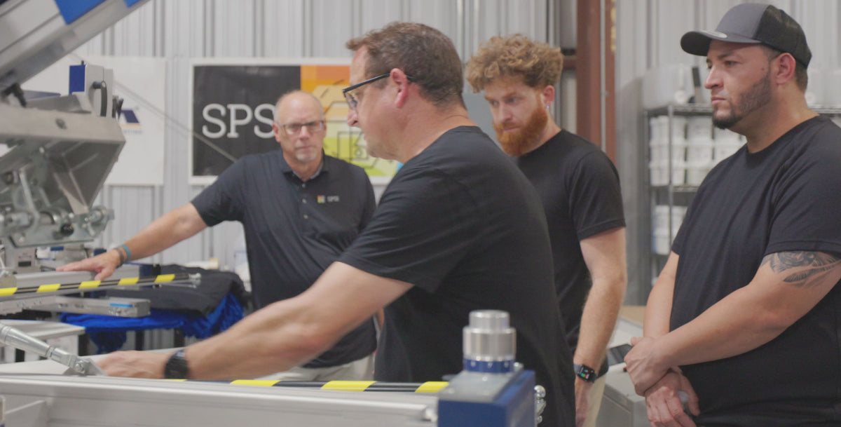 SPSI technician training a shop crew on a press